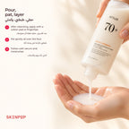 Anua Rice 70 Glow Milky Toner being poured into an open palm