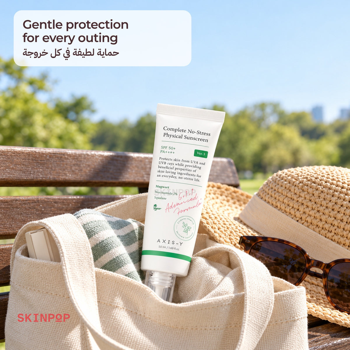 AXIS-Y Complete No-Stress Physical Sunscreen in a canvas tote with a straw hat and sunglasses