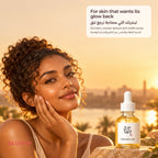 Woman with curly hair smiling at sunset with the Beauty of Joseon Glow Serum in front of a city skyline