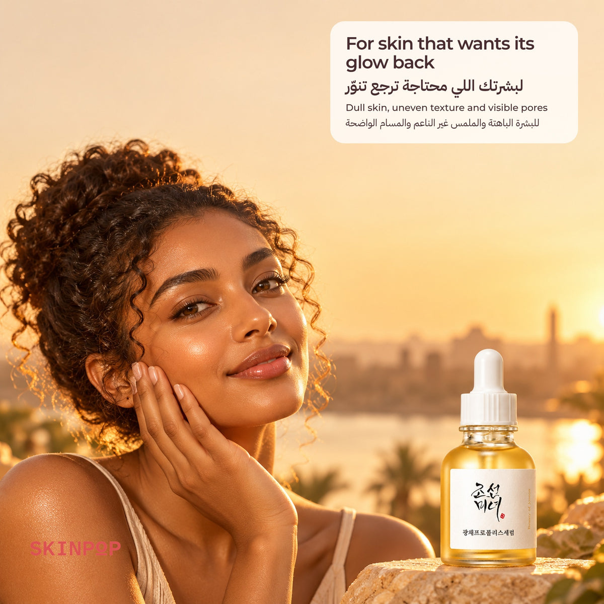 Woman with curly hair smiling at sunset with the Beauty of Joseon Glow Serum in front of a city skyline