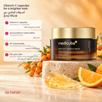Medicube Deep Vita C Capsule Cream on a stone with sea buckthorn berries, an orange slice and a gel swatch