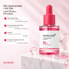 Medicube TXA Niacinamide 15 Serum on a marble block with clear pink glass spheres