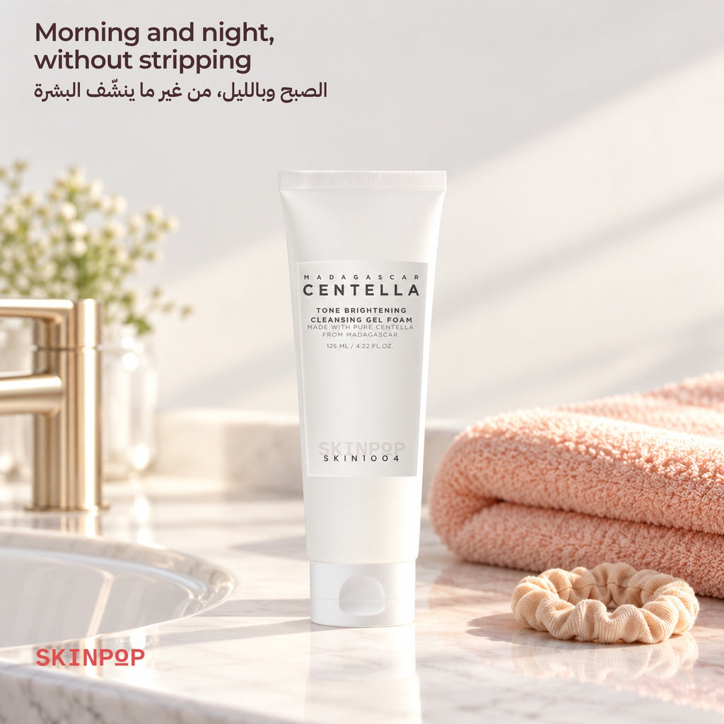 SKIN1004 Tone Brightening Cleansing Gel Foam on a bathroom counter next to a pink towel and a scrunchie
