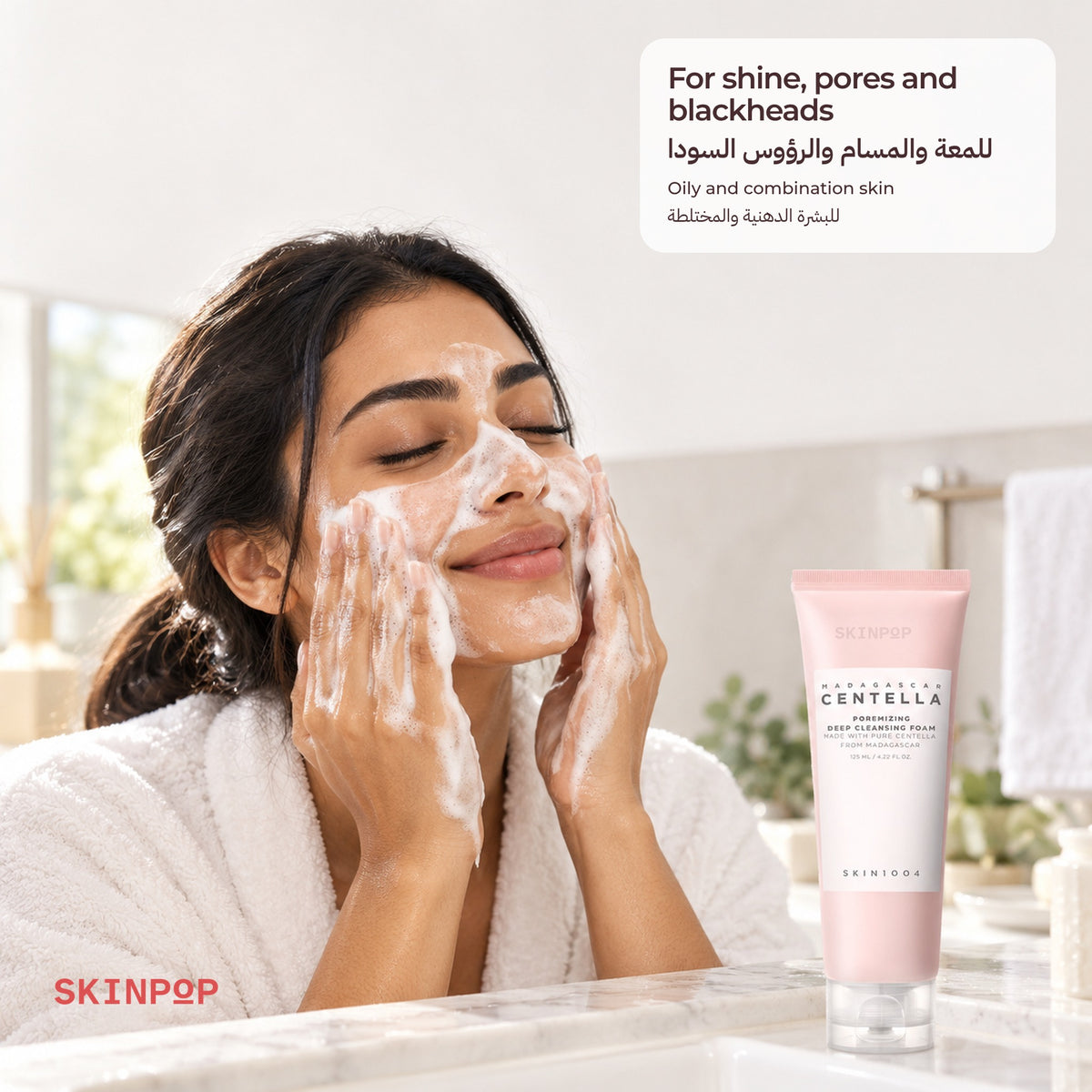 Woman in a robe with cleansing foam on her face beside the SKIN1004 Poremizing Deep Cleansing Foam