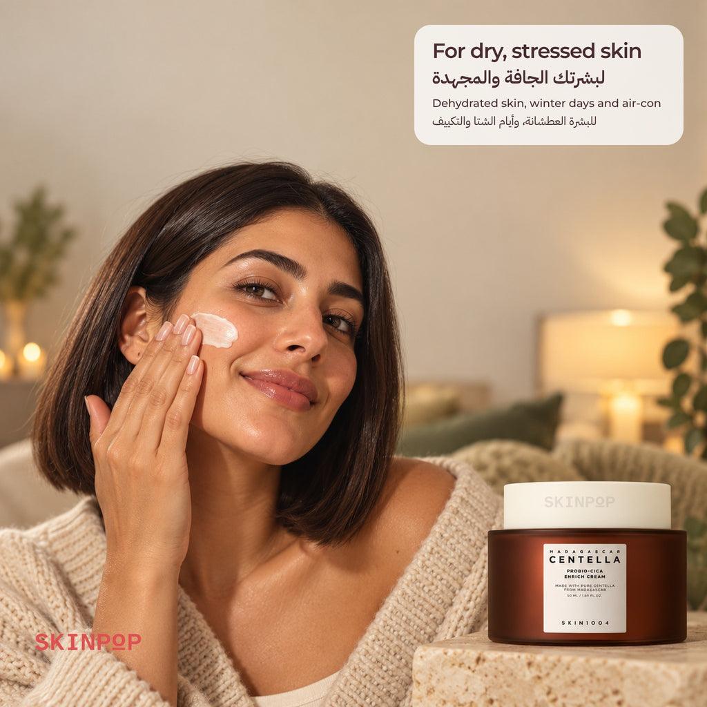 Woman with a bob applying cream to her cheek beside the SKIN1004 Probio-Cica Enrich Cream jar