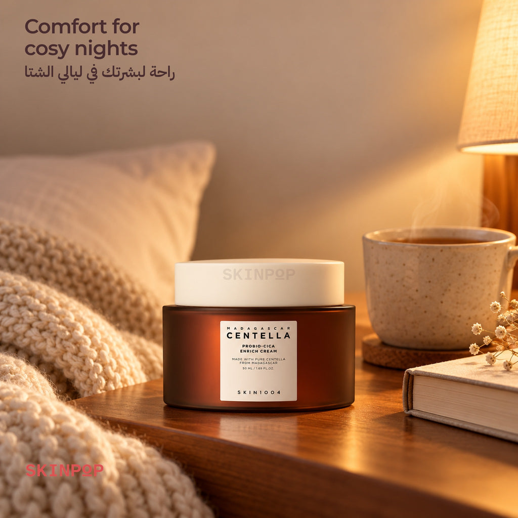 SKIN1004 Probio-Cica Enrich Cream on a bedside table with a knit blanket, a cup of tea and a book